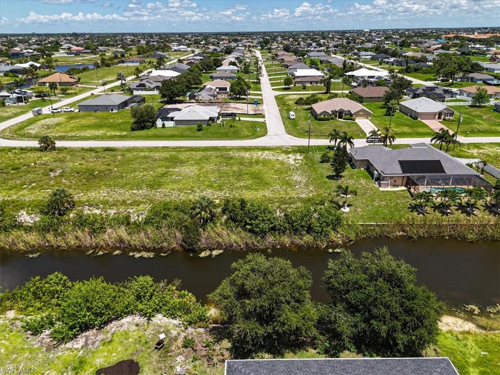 Aerial perspective of suburban area featuring a large body of water
