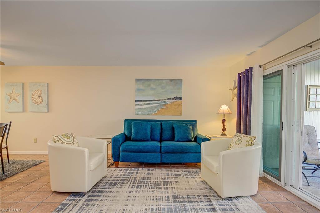 Living room with light tile patterned floors and baseboards