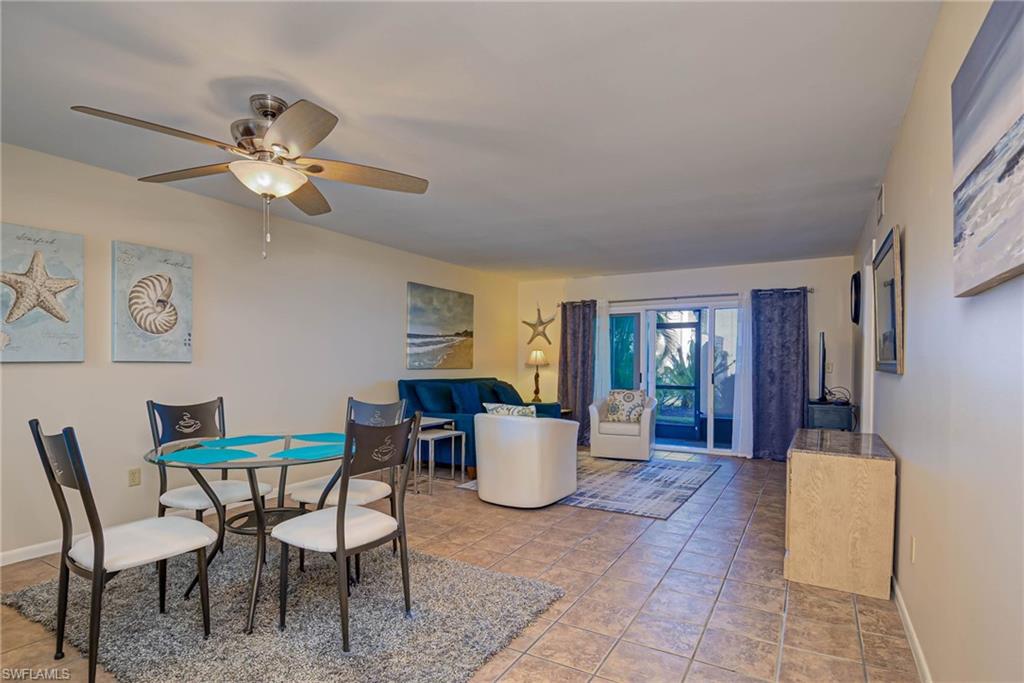 Dining space with light tile patterned floors and ceiling fan
