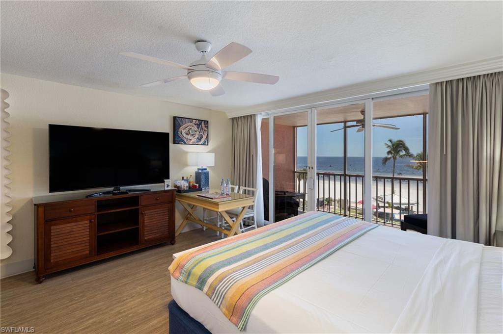 King bed with large TV and small seating area...and that screened balcony!!