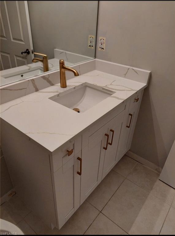 Bathroom featuring tile patterned floors and vanity