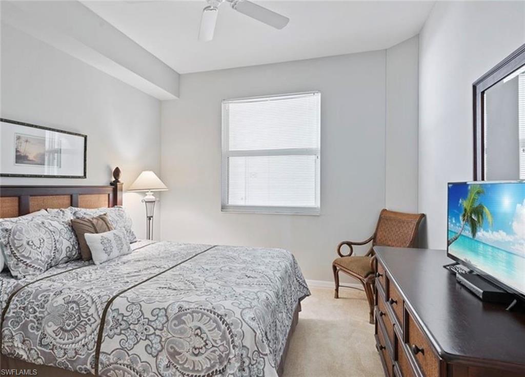 Laminated flooring in the bedroom featuring ceiling fan