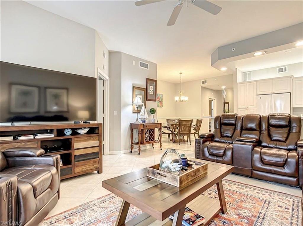 Living room featuring light tile patterned floors and ceiling fan with new furniture