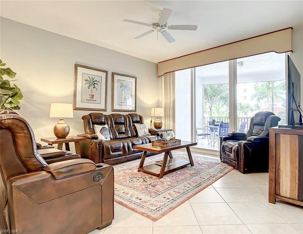 Living room featuring ceiling fan and light tile patterned flooring