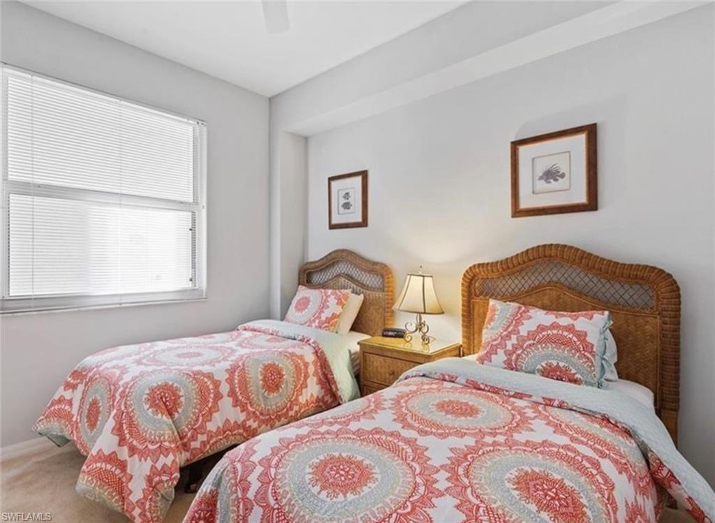Bedroom with ceiling fan and laminated floors