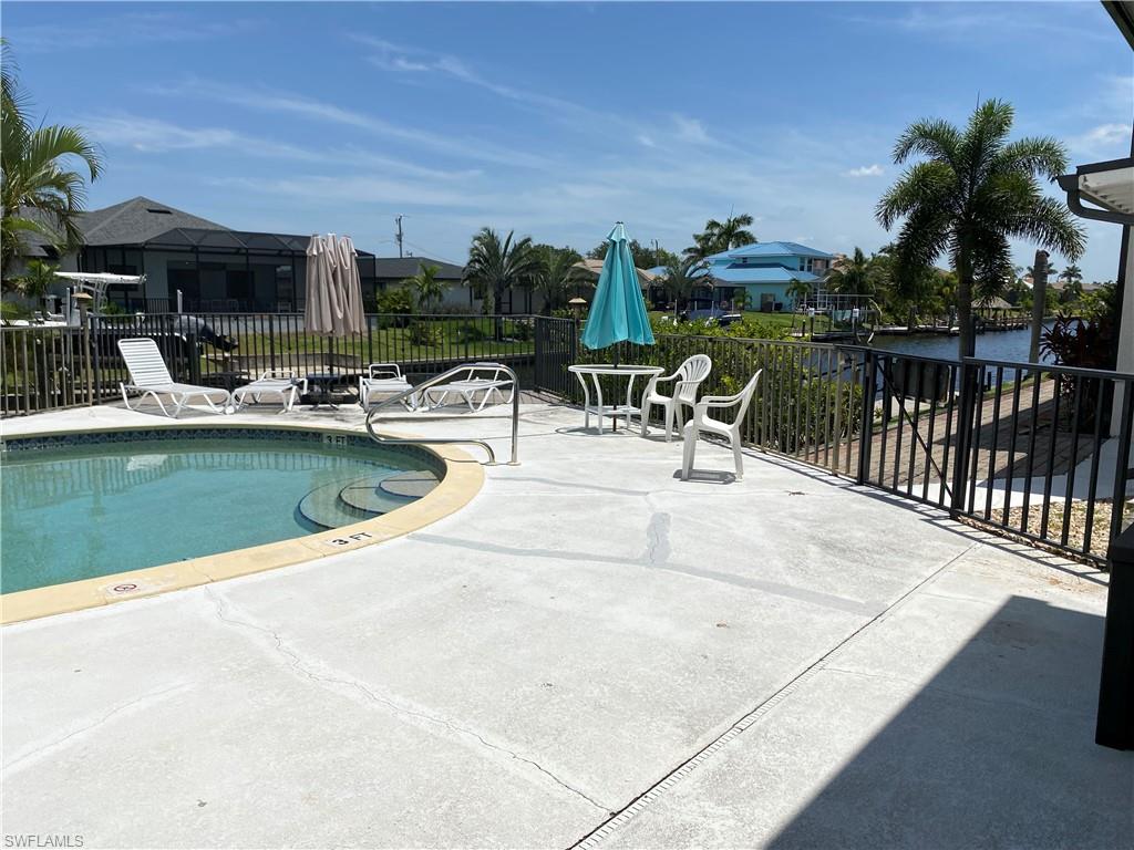 Community pool featuring a patio