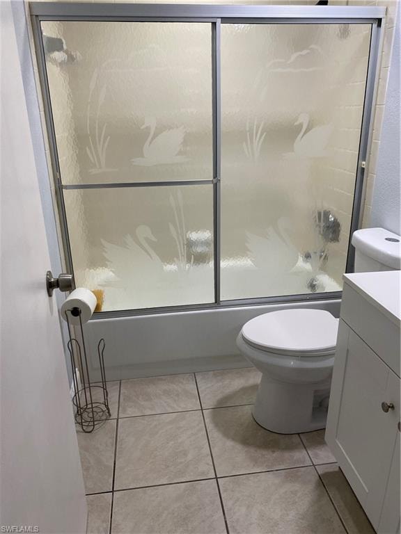 Bathroom with shower / bath combination with glass door, vanity, and light tile patterned floors