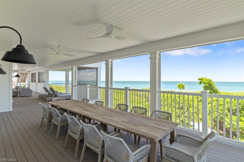 Sunroom / solarium featuring hardwood / wood-style flooring, a water view, and wooden ceiling
