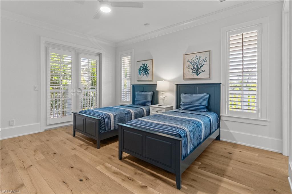 Bedroom with access to outside, ornamental molding, light wood finished floors, and ceiling fan