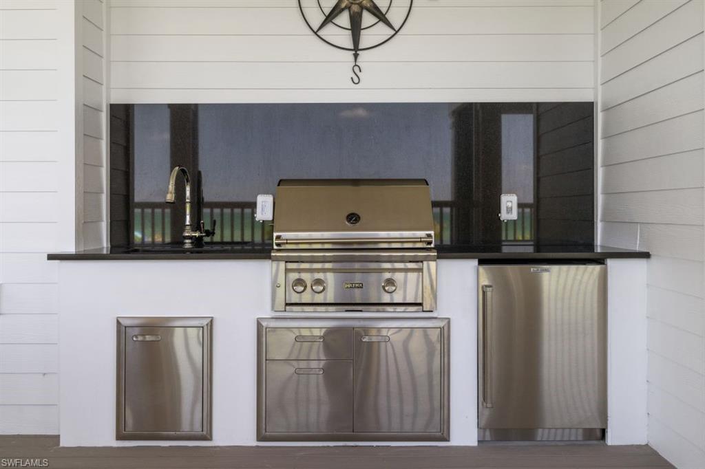 View of patio featuring area for grilling and a sink