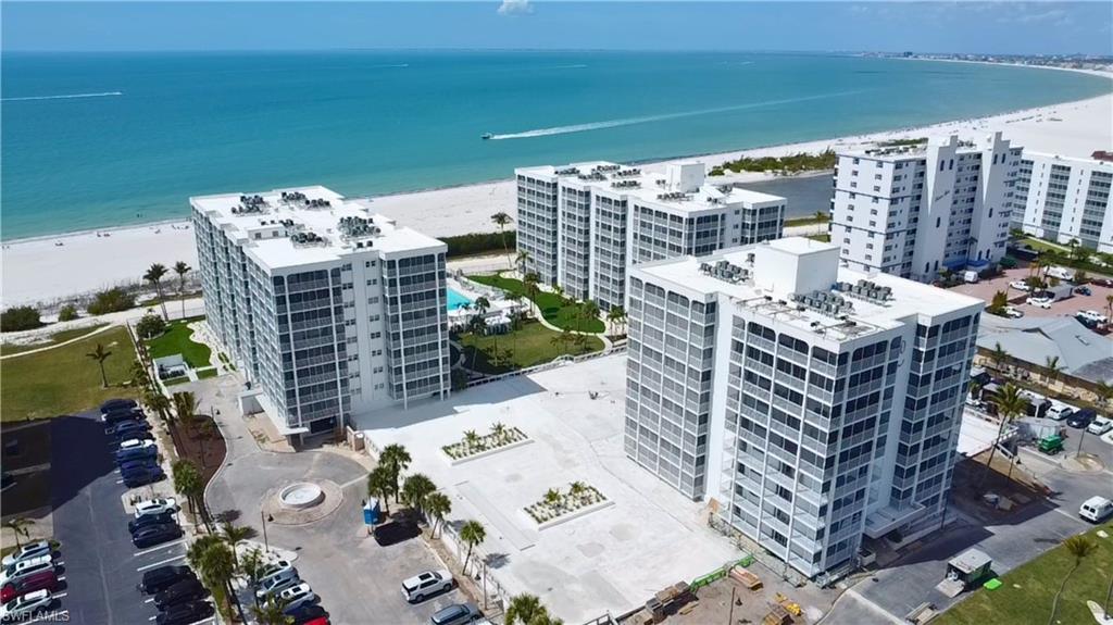 Aerial view of condominium complex and expansive beach - Virtually Edited Image