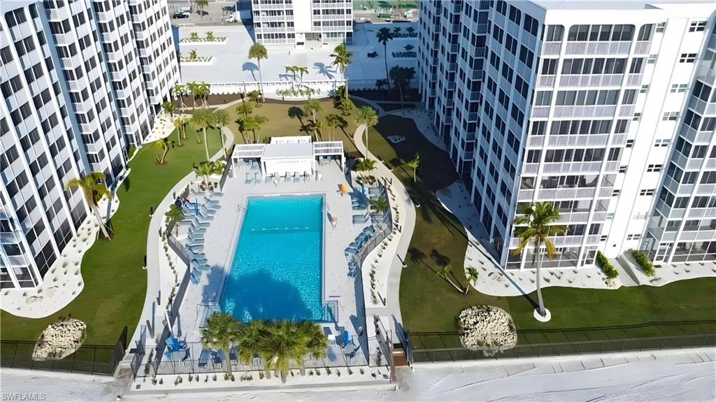 Drone / aerial view of apartment complex and a pool area - Virtually Edited Image