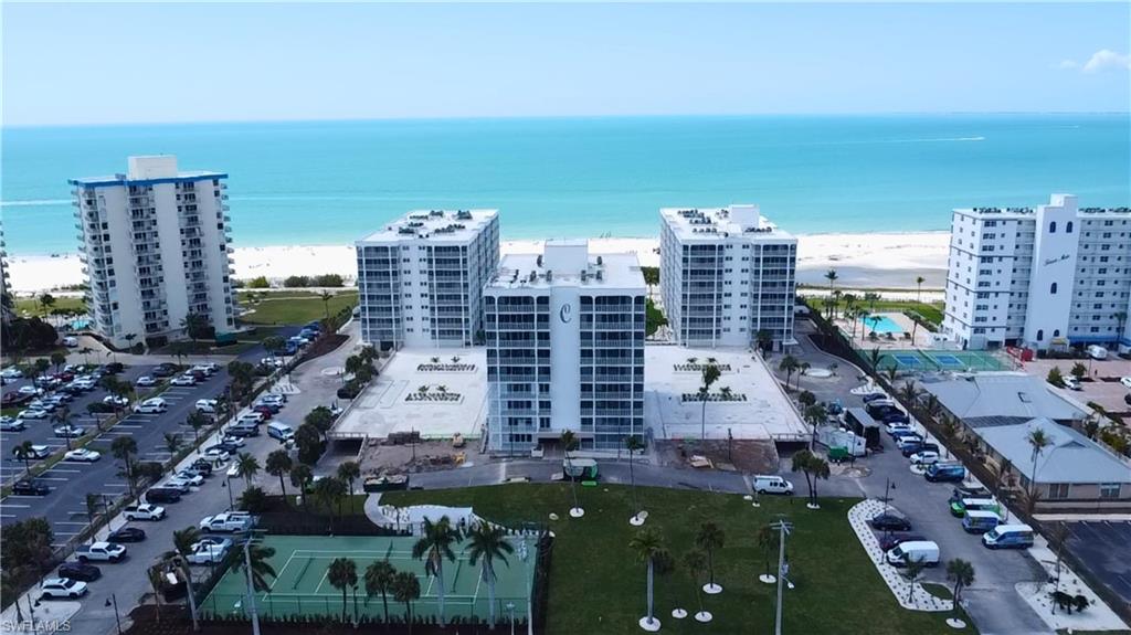 Bird's eye view of condominium complex / building & tennis courts - Virtually Edited Image