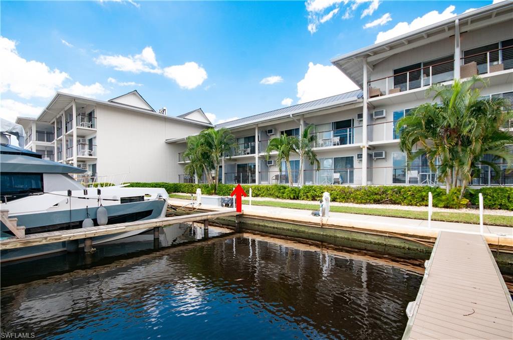 View of dock featuring a balcony and a water view