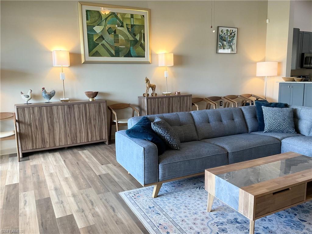 Living room featuring lightwood style laminate flooring