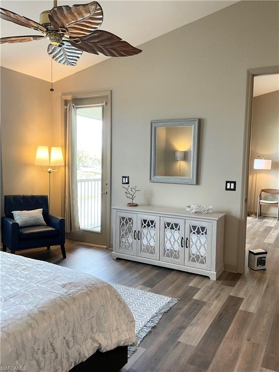 Primary Bedroom featuring king bed, access to lanai, lofted ceiling, wood-style flooring, and ceiling fan