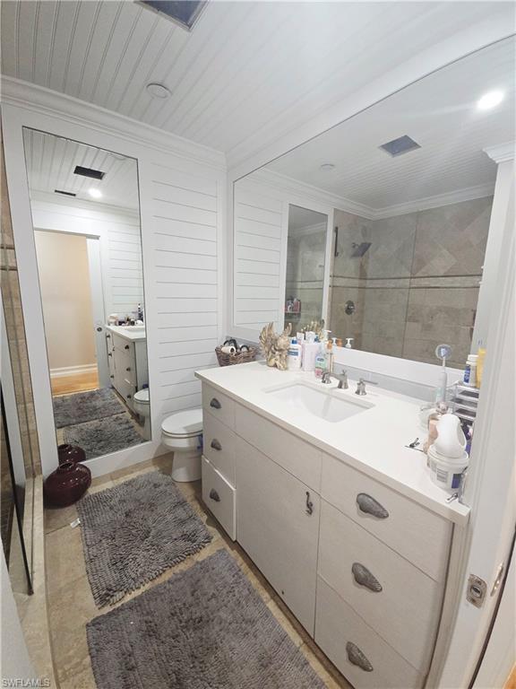 Bathroom with vanity, a tile shower