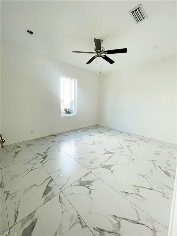 Unfurnished room featuring a ceiling fan