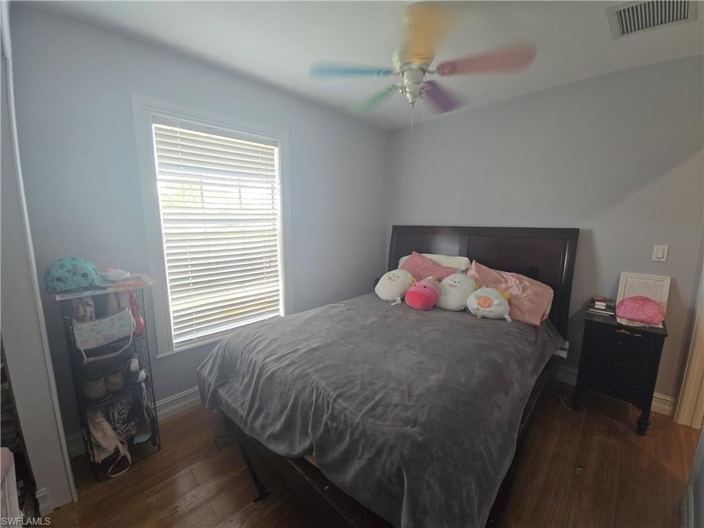 Bedroom featuring dark wood-type flooring and a ceiling fan