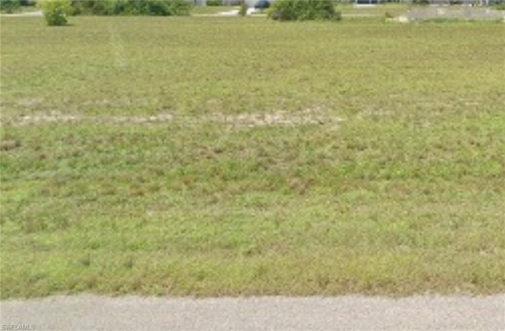 View of green lawn featuring a rural view