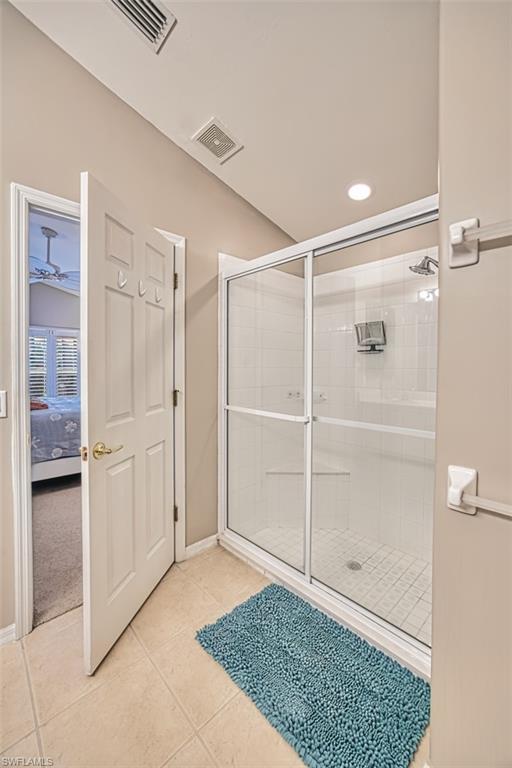 Full bath with a shower stall, light tile patterned floors, ensuite bathroom, and recessed lighting