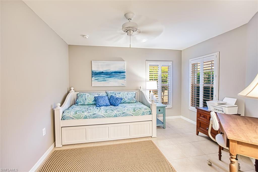 Bedroom featuring light tile patterned floors and ceiling fan
