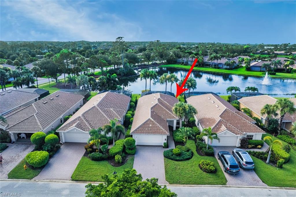 Aerial perspective of suburban area featuring a nearby body of water
