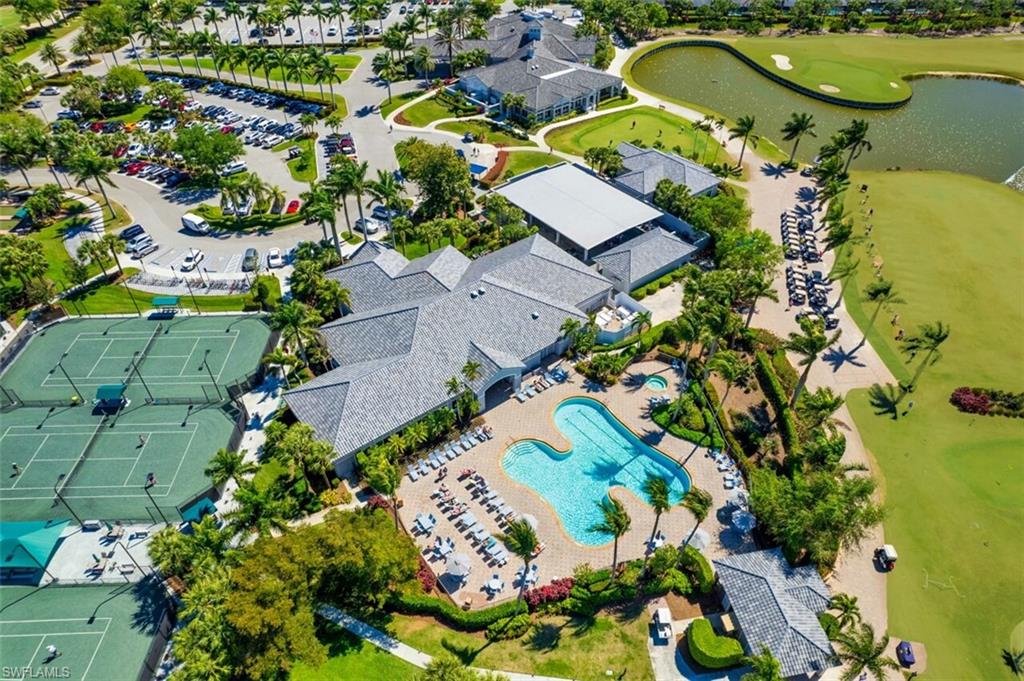 Aerial view of residential area with a nearby body of water and a golf club