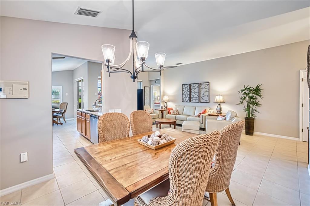 Dining area with a chandelier and light tile patterned floors