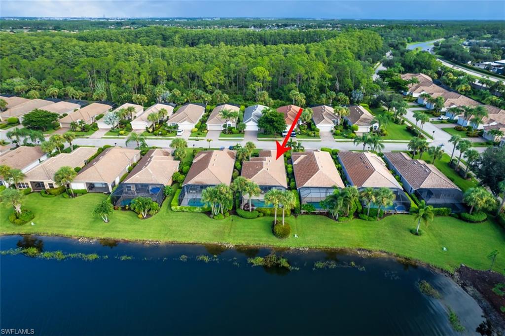 Aerial overview of property's location with a nearby body of water and nearby suburban area