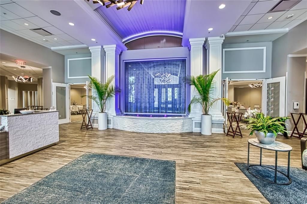 Reception area with recessed lighting, a high ceiling, and a chandelier