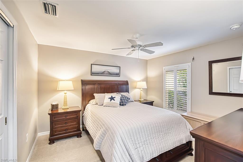 Bedroom featuring light carpet and ceiling fan
