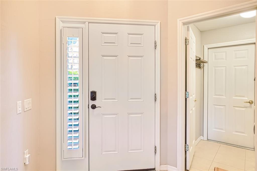 Foyer entrance featuring light tile patterned floors and baseboards
