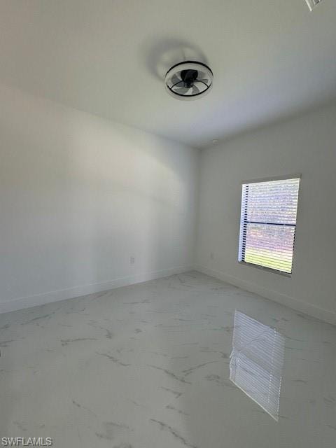 2-bedroom featuring baseboards and light marble finish flooring