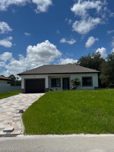 Single story home with stucco siding, a front lawn, an attached garage, decorative driveway, and a shingled roof