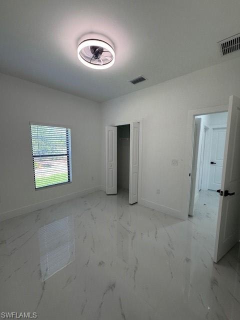 2-Unfurnished bedroom featuring a closet and light marble finish floors