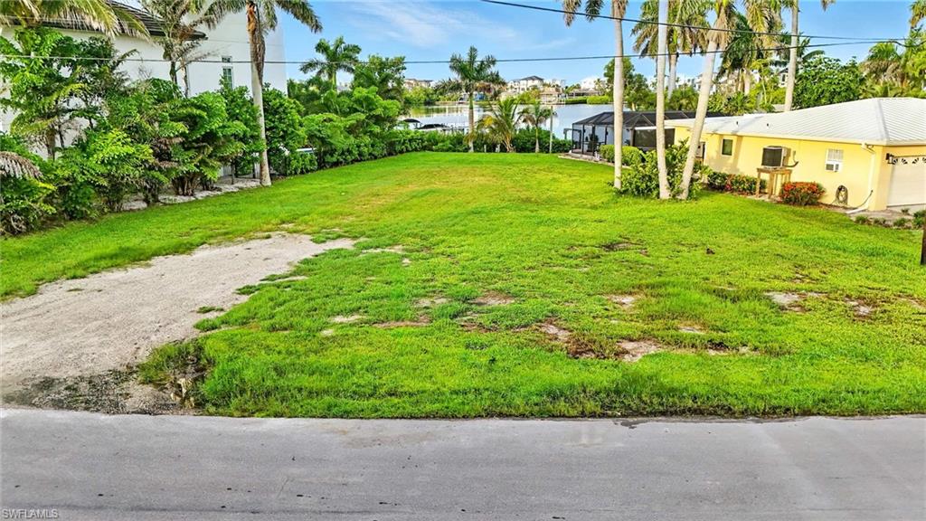 View of grassy yard with a water view
