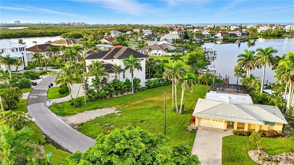 Aerial view of residential area featuring a nearby body of water