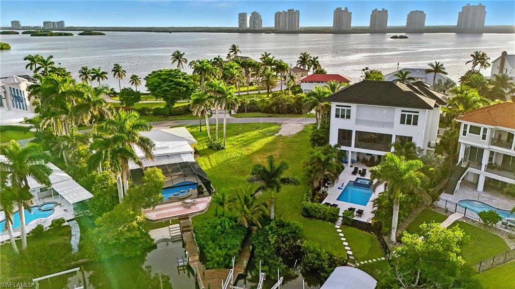 View of urban area with a pool area and a nearby body of water
