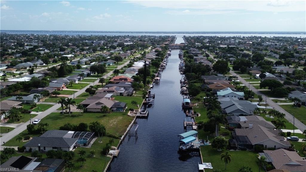 View of property location featuring a large body of water and nearby suburban area