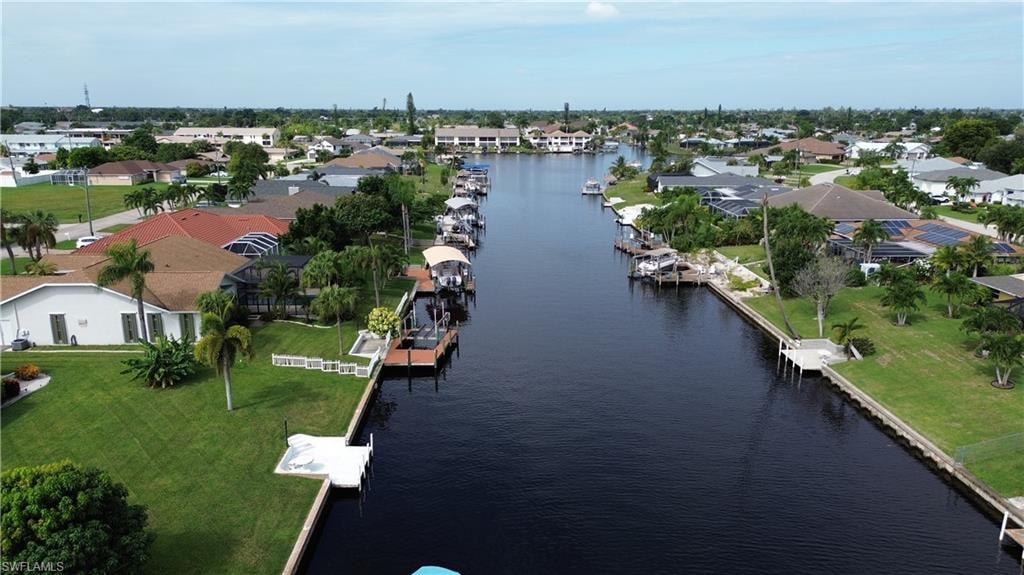 Aerial view of residential area featuring a large body of water