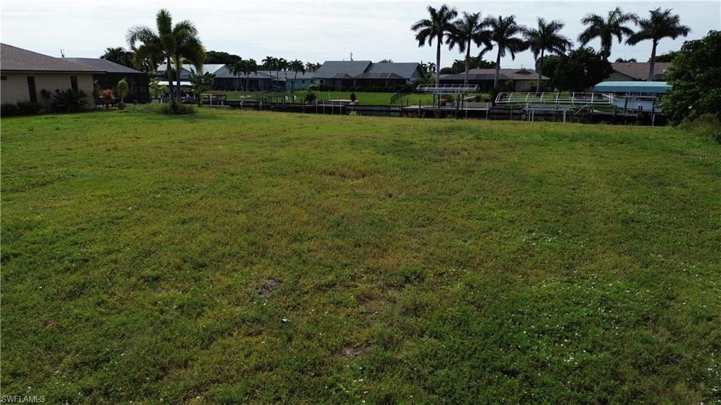 View of green lawn featuring a residential view