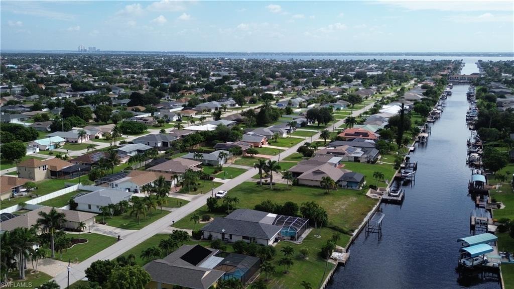 Aerial overview of property's location with a large body of water and nearby suburban area
