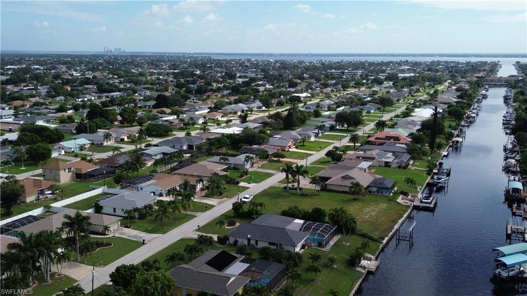 Aerial overview of property's location with a large body of water and nearby suburban area
