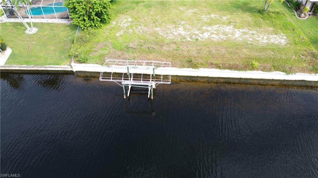 Drone / aerial view of a large body of water and a pool area
