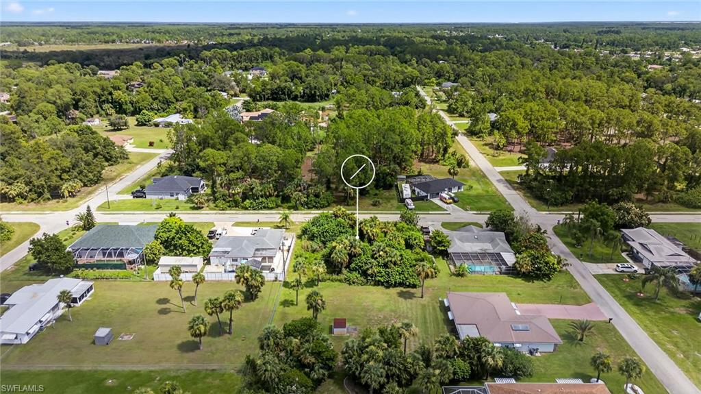 Aerial view of property and surrounding area featuring nearby suburban area