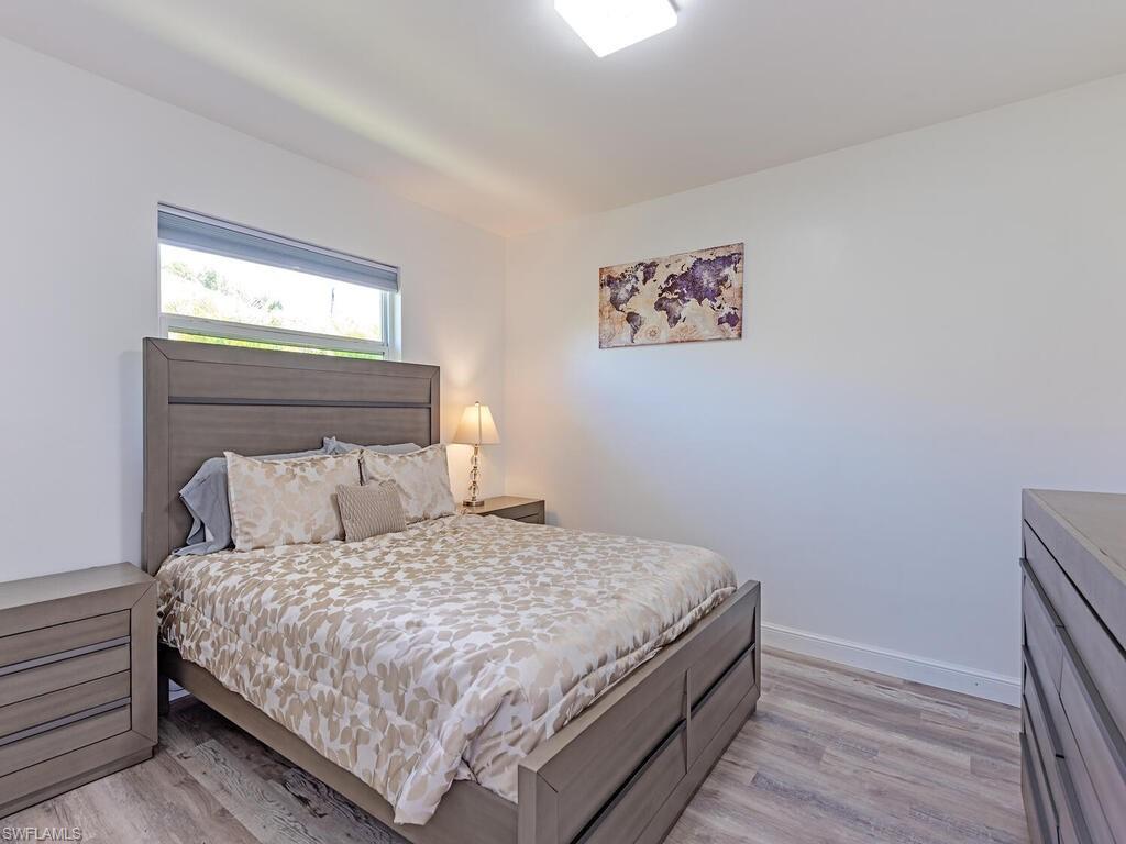 Bedroom featuring light wood-style floors and baseboards