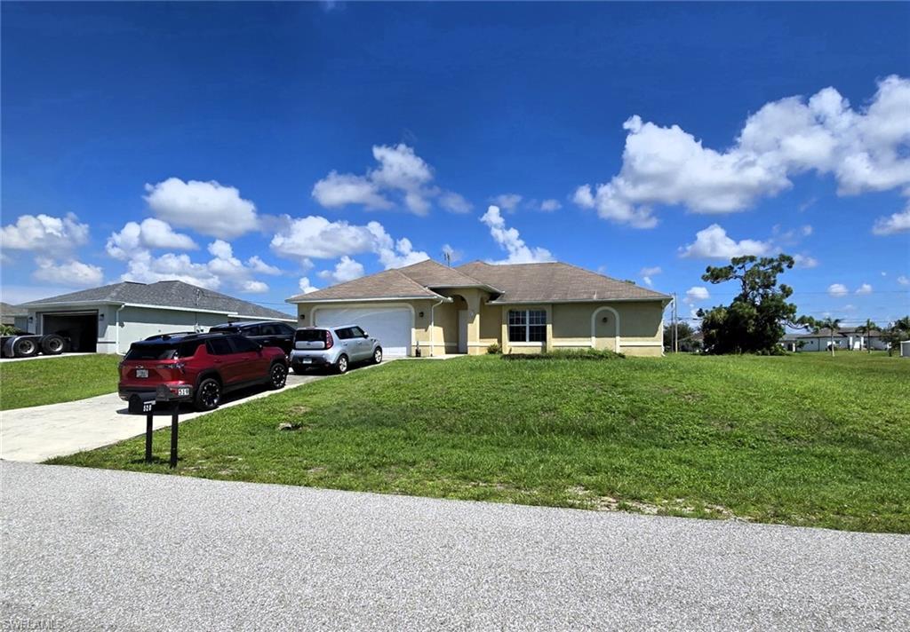 Ranch-style house with stucco siding, an attached garage, concrete driveway, and a front lawn