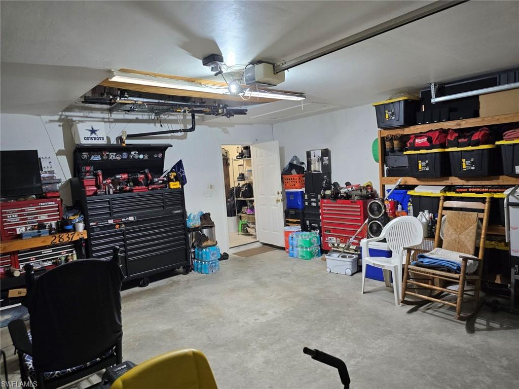 Garage featuring a workshop area and a garage door opener