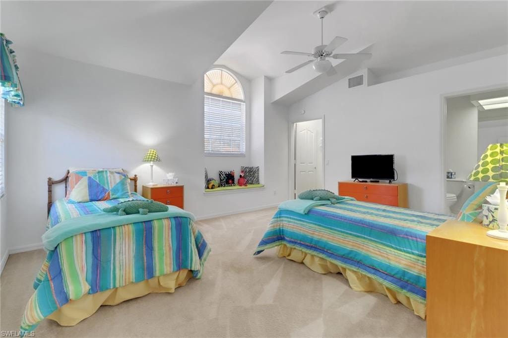 Guest bedroom #2 with vaulted ceiling, walk in closet, en suite bathroom